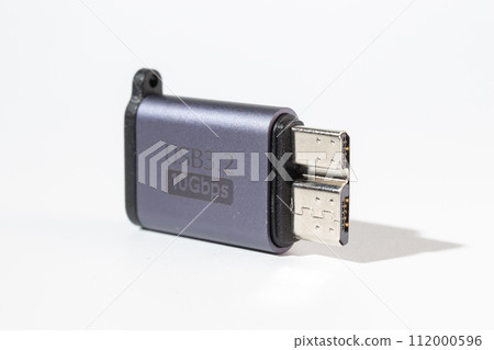 Isolated dark gray USB With HDD adapter on a white background. Isolated dark gray USB With HDD adapter on a white background. 112000596