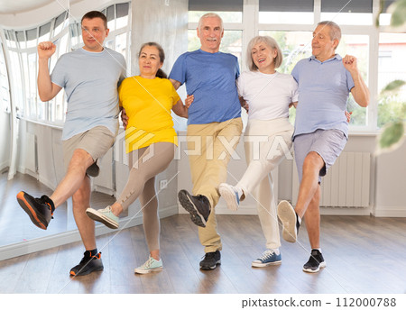 Group of elderly men and women dancing folk dances Group of elderly men and women dancing folk dances 112000788