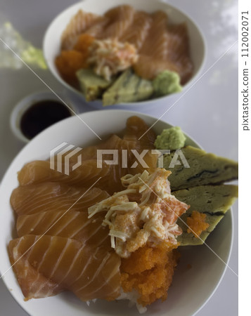 Salmon topped rice served with wasabi and soy sauce Salmon topped rice served with wasabi and soy sauce 112002071