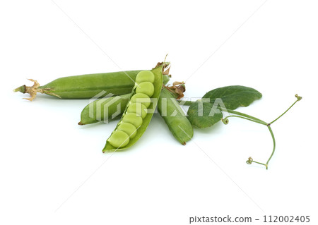 Open pea pod and round green peas inside on white 112002405