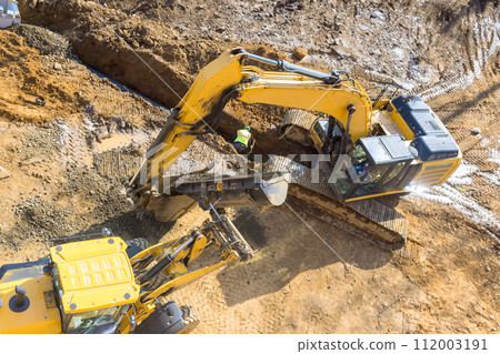 In this large excavator is digging on an industrial site that is being developed an infrastructure project In this large excavator is digging on an industrial site that is being developed an infrastructure project 112003191