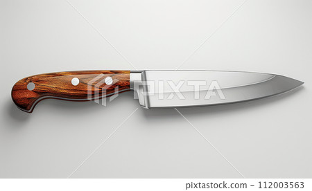 A chef's knife with a reflective blade and a finely crafted wooden handle is presented on a light background, highlighting its sleek design and sharpness. 112003563