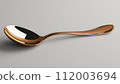 A single copper spoon with a reflective surface on a neutral grey background. 112003694