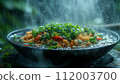 A steaming bowl of fried rice with green peas, carrots, and scallions, captured in a refreshing rain ambiance. 112003700