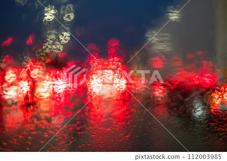 Rainy Night Traffic Lights Bokeh on Windshield Rainy Night Traffic Lights Bokeh on Windshield 112003985