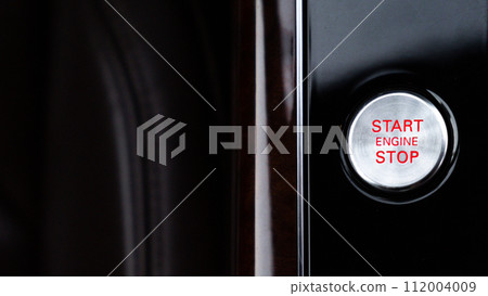 Start engine stop button Interior of modern luxury car. Details of automatic transmission gear shift, multimedia control system, car control panel, Air Vent Red emergency button and dashboard inside Start engine stop button Interior of modern luxury car. Details of automatic transmission gear shift, multimedia control system, car control panel, Air Vent Red emergency button and dashboard inside 112004009