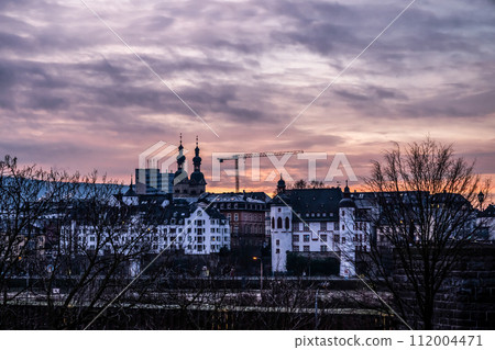 Sunset colorfull sunrise in Koblenz, Germany view of Old Town at the Mosel river shoreline Sunset colorfull sunrise in Koblenz, Germany view of Old Town at the Mosel river shoreline 112004471