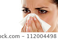 beautiful woman blowing her nose 112004498