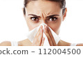 Woman blowing her nose 112004500