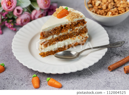Homemade carrot cake made with walnuts, iced with cream cheese. Sweet dessert. Homemade carrot cake made with walnuts, iced with cream cheese. Sweet dessert. 112004525