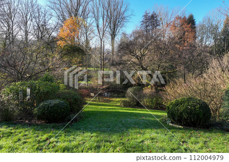 Enlgish green garden with water pound and multpiple type of trees and plants 112004979