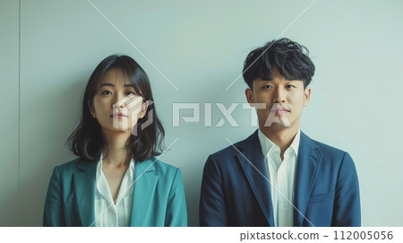 Casual male and female office workers standing side by side 112005056