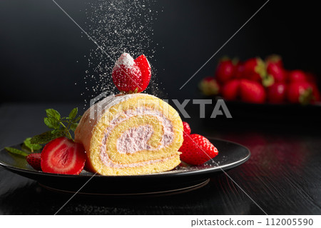 Delicious strawberry biscuit cake sprinkled with sugar powder. Delicious strawberry biscuit cake sprinkled with sugar powder. 112005590