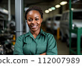 Expert female auto technician at work. Adept african american woman auto mechanic in workshop, showcasing her expertise and command in the field of car technology. 112007989