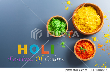 Happy Holi decoration, the indian festival.Top view of colorful holi powder on dark background. Happy Holi decoration, the indian festival.Top view of colorful holi powder on dark background. 112008864