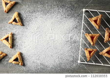A mask with traditional cookies for the day of Purim. 112010355