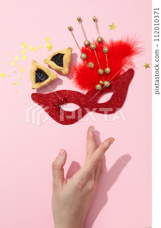 A mask with traditional cookies for the day of Purim. 112010371