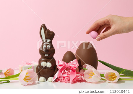 Chocolate bunny with fresh flowers and gifts 112010441