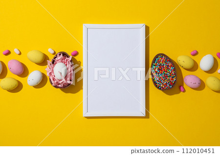 Chocolate eggs with a white blank plate Chocolate eggs with a white blank plate 112010451