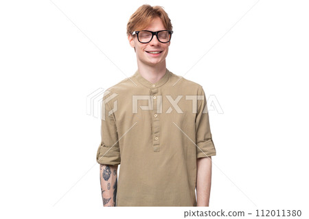 young handsome caucasian guy with red hair in a brown shirt young handsome caucasian guy with red hair in a brown shirt 112011380