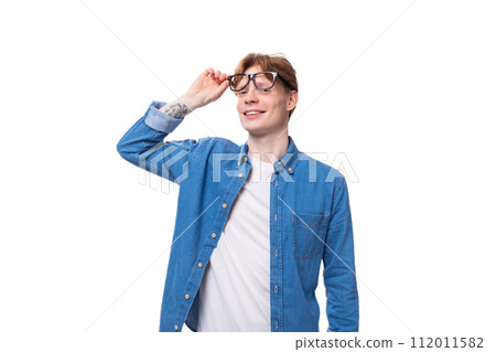 young kind cute european man with copper hair wears denim shirt and white t-shirt young kind cute european man with copper hair wears denim shirt and white t-shirt 112011582