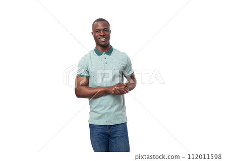 portrait of a young positive short-haired american man dressed in a mint summer t-shirt on a white 112011598