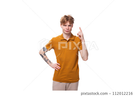 a young handsome red-haired man with a haircut and a tattoo on his arm tells the news. advertising a young handsome red-haired man with a haircut and a tattoo on his arm tells the news. advertising 112012216