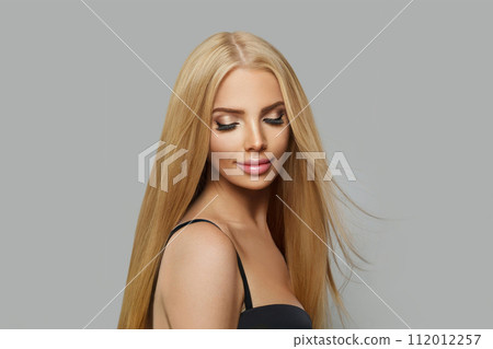 Good-looking blonde female model with make-up and straight healthy shiny hairstyle 112012257