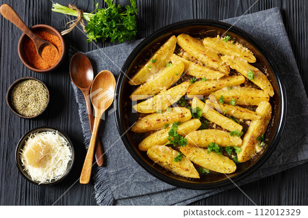 greek lemon potatoes with garlic, cheese on dish 112012329