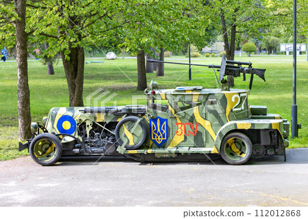 The armored car is stylized as an antique car, painted in camouflage colors with the coat of arms of Ukraine. 05.09.2023. Kyiv, Ukraine. 112012868