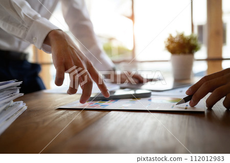 Closeup shot of creative team brainstorming for mobile application software design project at office Closeup shot of creative team brainstorming for mobile application software design project at office 112012983