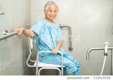 Asian elderly woman patient use toilet bathroom handle security in nursing hospital, healthy strong medical concept. 112013539
