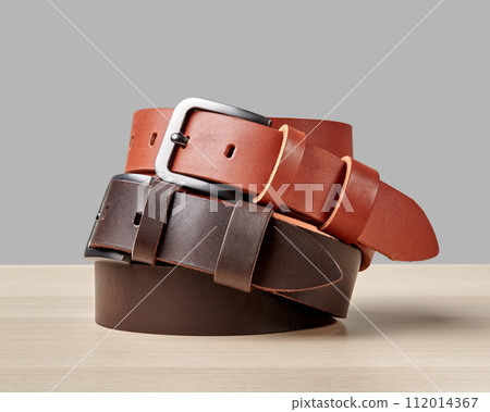 Folded terracotta and brown leather belts with DAD embossing 112014367