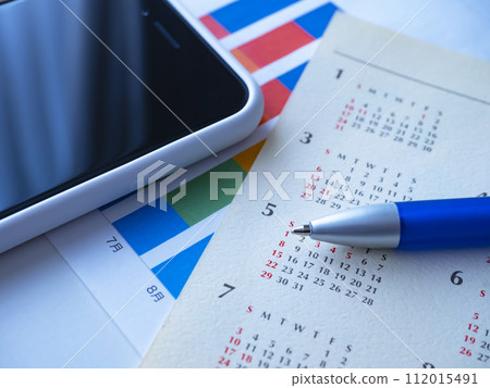 Graphs, calendars and smartphones placed on the table Graphs, calendars and smartphones placed on the table 112015491