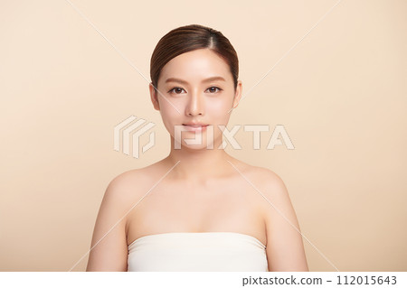 Beautiful young asian woman with clean fresh skin on beige background, Face care, Facial treatment, Cosmetology, beauty and spa, Asian women portrait. Beautiful young asian woman with clean fresh skin on beige background, Face care, Facial treatment, Cosmetology, beauty and spa, Asian women portrait. 112015643