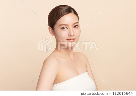 Beautiful young asian woman with clean fresh skin on beige background, Face care, Facial treatment, Cosmetology, beauty and spa, Asian women portrait. 112015644