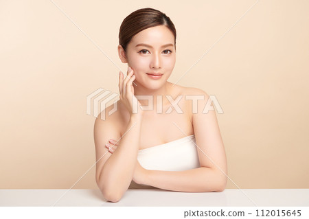 Beautiful young asian woman with clean fresh skin on beige background, Face care, Facial treatment, Cosmetology, beauty and spa, Asian women portrait. 112015645