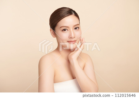 Beautiful young asian woman with clean fresh skin on beige background, Face care, Facial treatment, Cosmetology, beauty and spa, Asian women portrait. Beautiful young asian woman with clean fresh skin on beige background, Face care, Facial treatment, Cosmetology, beauty and spa, Asian women portrait. 112015646