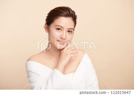 Beautiful young asian woman with clean fresh skin on beige background, Face care, Facial treatment, Cosmetology, beauty and spa, Asian women portrait. Beautiful young asian woman with clean fresh skin on beige background, Face care, Facial treatment, Cosmetology, beauty and spa, Asian women portrait. 112015647