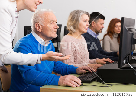 Focused senior man during computer classes 112015753