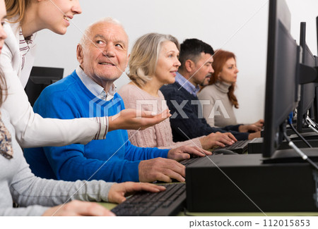 Enthusiastic senior man taking computer lessons Enthusiastic senior man taking computer lessons 112015853