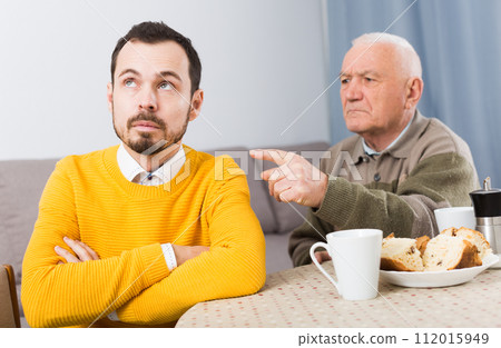 Aged father teaches his son 112015949