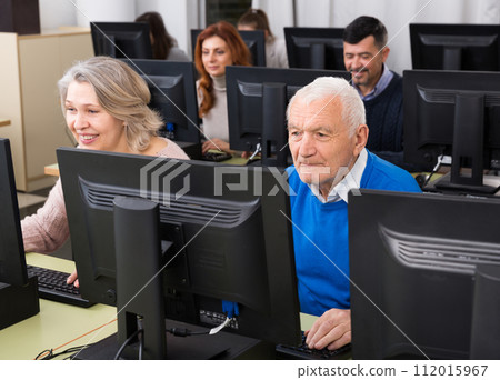 People of different age studying in computer class 112015967
