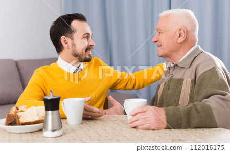 Elderly father and son breakfast Elderly father and son breakfast 112016175