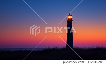 A solitary lighthouse standing against a dusky sky A solitary lighthouse standing against a dusky sky 112016283