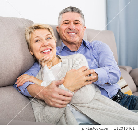 glad mature married couple in house are warmly reconciled after quarrel glad mature married couple in house are warmly reconciled after quarrel 112016461