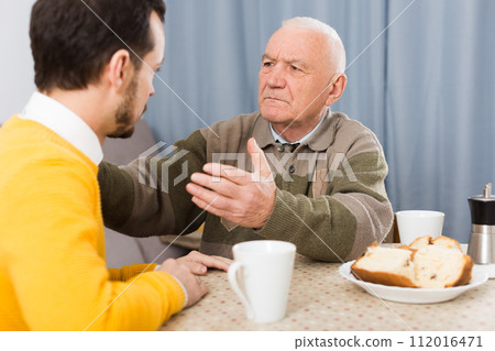 Aged father teaches his son 112016471