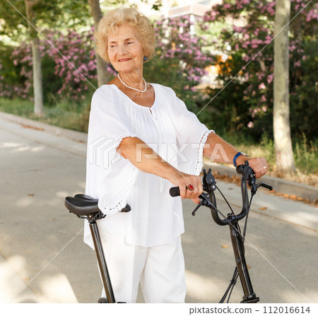 Elderly woman going to biking 112016614