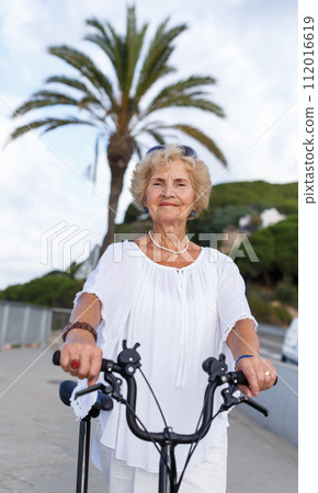 Elderly woman going to biking 112016619