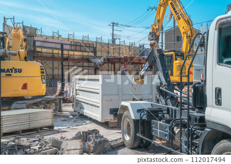 Demolition work site Heavy machinery and arm roll truck Demolition work site Heavy machinery and arm roll truck 112017494
